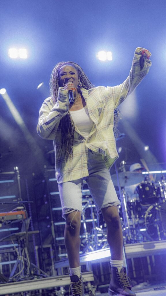 Female vocalist raising a fist on stage